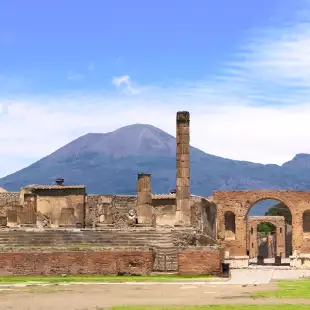 Ruins of Pompeii and a distant view of Mount Vesuvius volcano in Italy